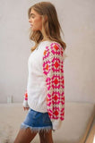 White sweater with pink & orange crochet sleeves (side) 