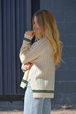 Cream sweater with green trim