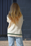 Cream sweater with green trim