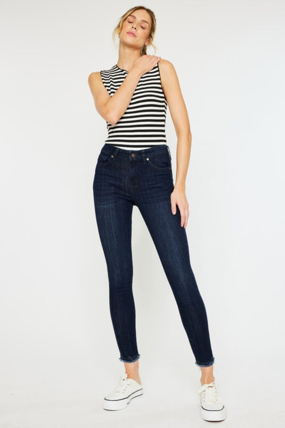 Super dark wash mid rise skinny jean with ankle frays