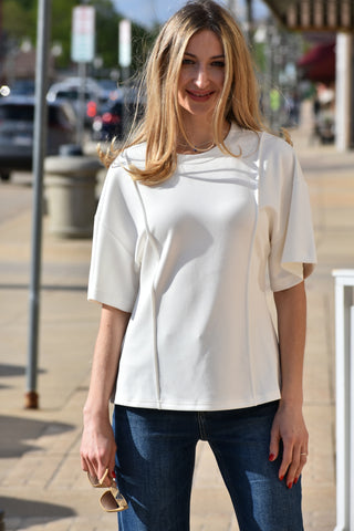 Super soft short sleeve top, hip length hemline, round neck. Seaming down front sides. Available in ivory or black